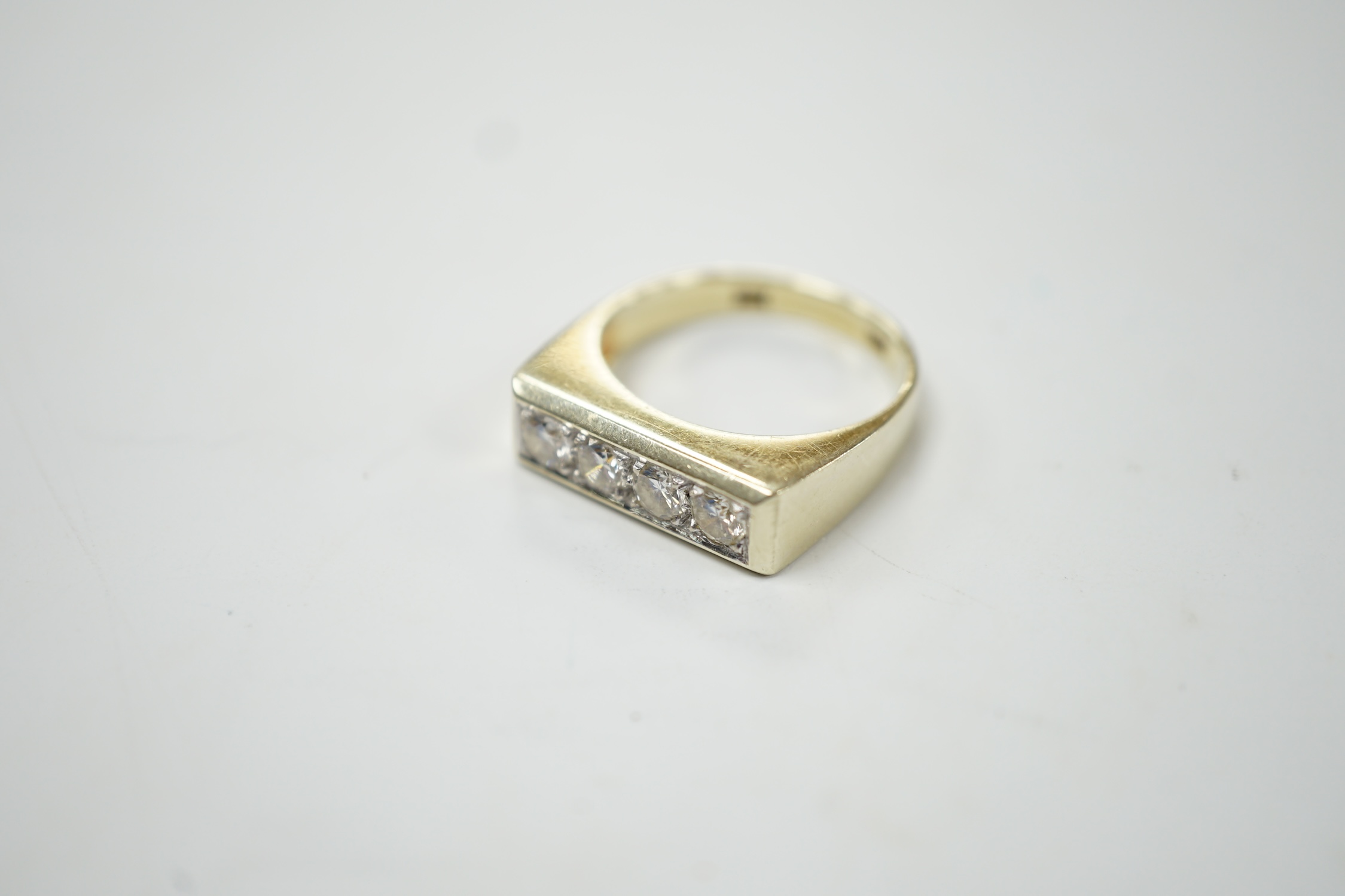 A 585 yellow metal and channel set four stone diamond ring, size P, gross weight 6.2 grams. Good condition.